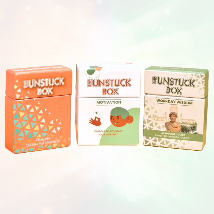 The Daily Spark Bundle ⚡️: Trio of “Unstuck Box” sets, each with motivational cards for creativity, workday motivation, and wisdom, featuring vibrant packaging and inspiring text.
