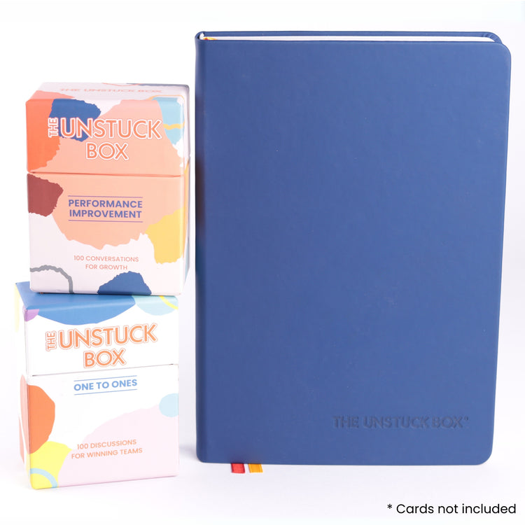 The Unstuck Box®: One to Ones Planner, a hardcover book with elastic closure and ribbon bookmarks, designed for managers to enhance 1-1 meeting effectiveness.